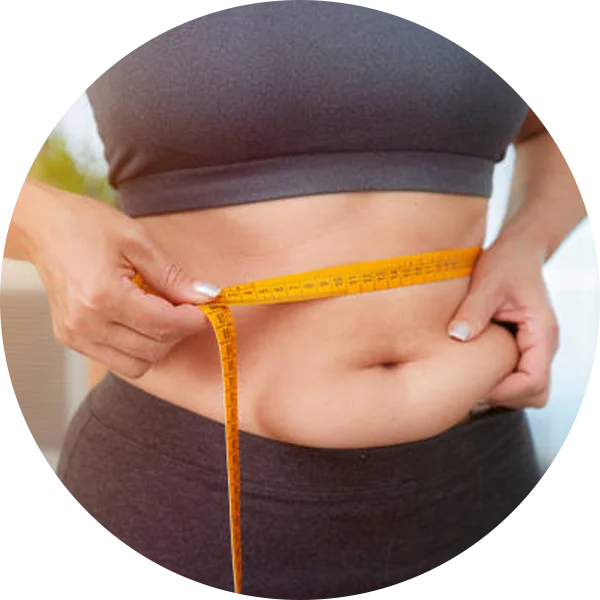 Woman measuring her waist with a tape measure, symbolizing mild weight gain commonly seen in PCOD.