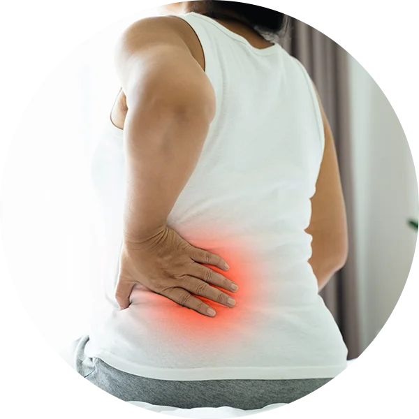 Person holding lower back with radiating pain toward the buttocks, indicating sharp sciatic pain.